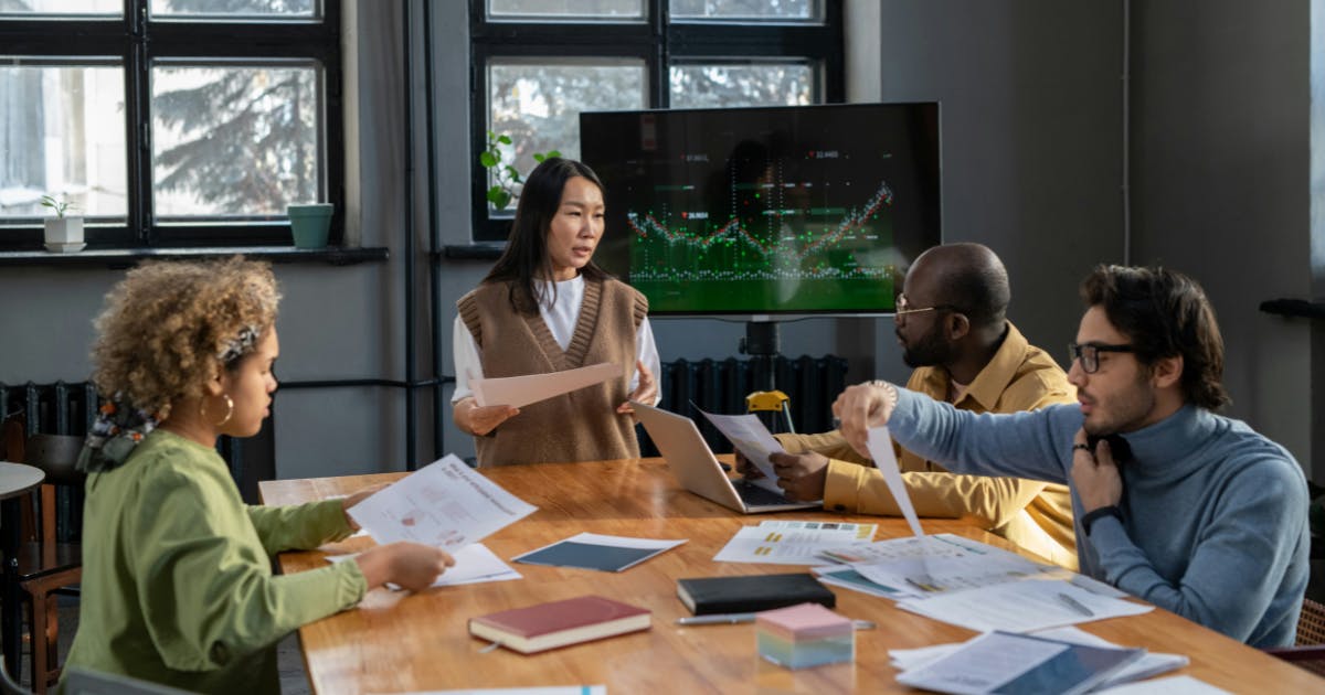 A diverse team of employees engaged in a productive meeting, showcasing the importance of inclusivity and collaboration in achieving business success.