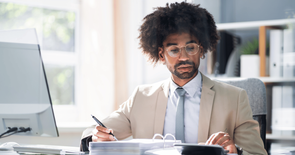 Accounting professional sorting documents, highlighting manual steps in accounts payable outsourcing services